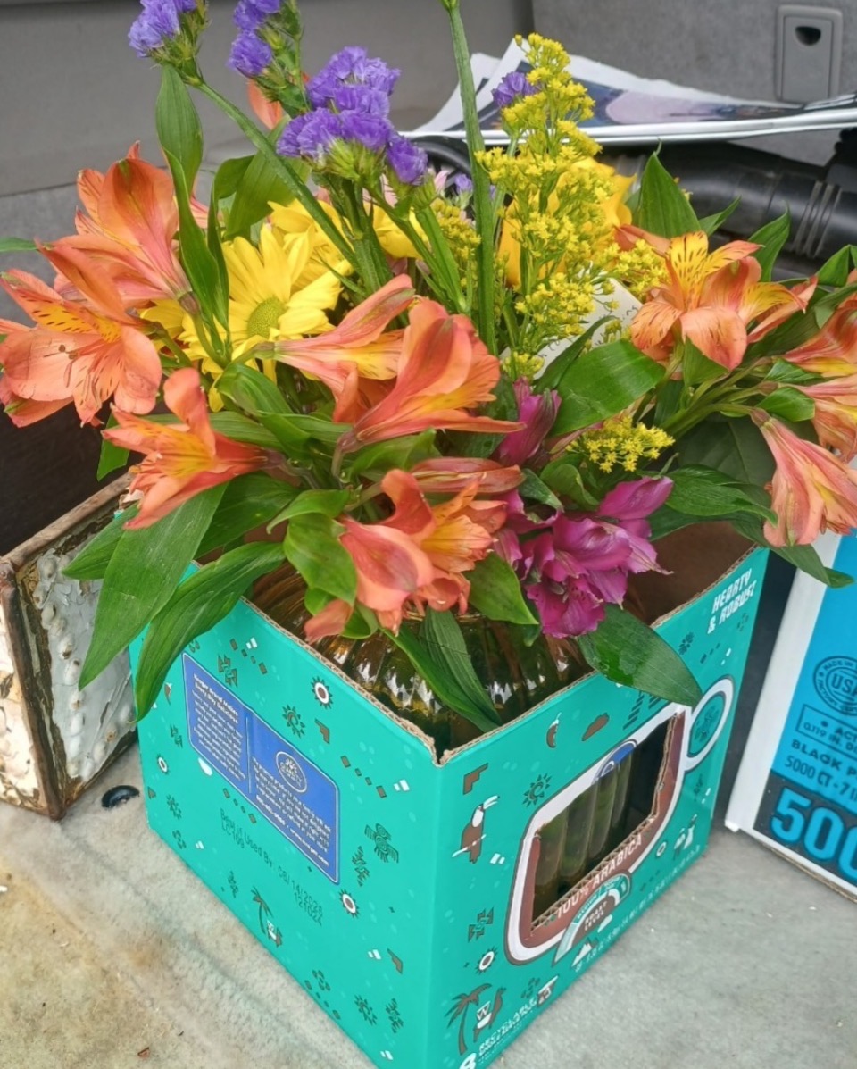 Orange alstroemeria arrangement in a coffee box