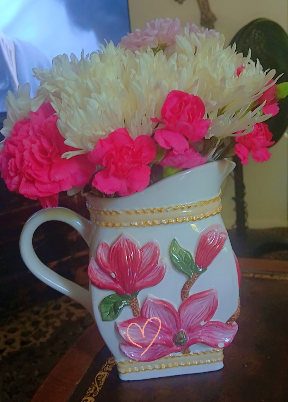 White mums and pink carnations in a floral pitcher