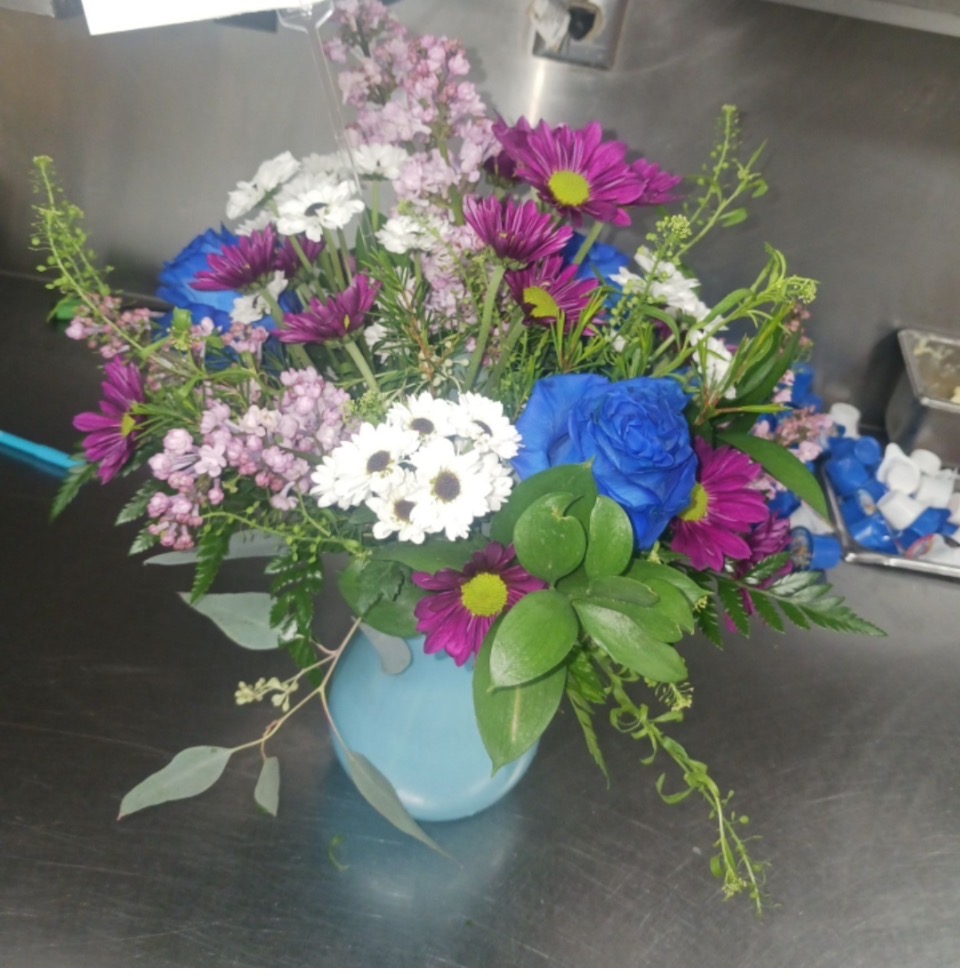 Blue rose and purple daisy arrangement